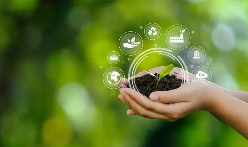 Illustration of sustainability icons in a hand holding the Earth