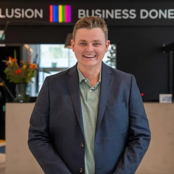 Lachende man in colbert staat in de centrale hal van Conclusion.