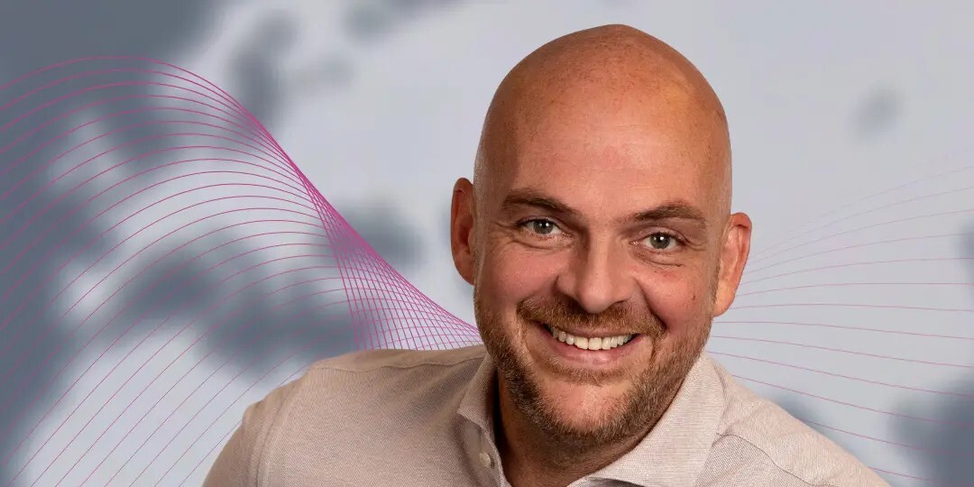 Bald man looking at the camera.