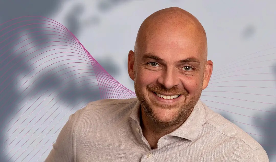 Bald man looking at the camera.