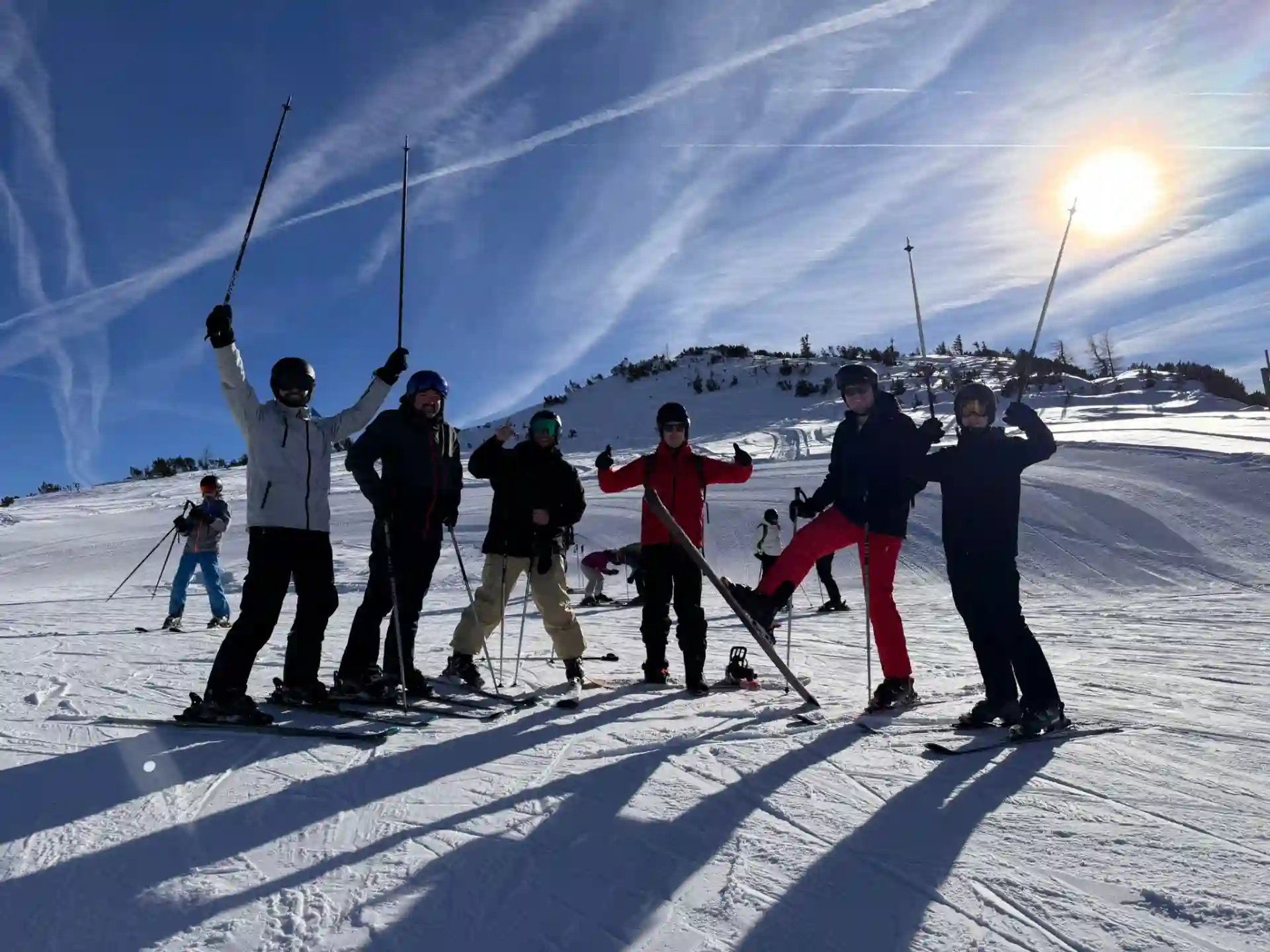 Group of six people on the slope with some sunshine.